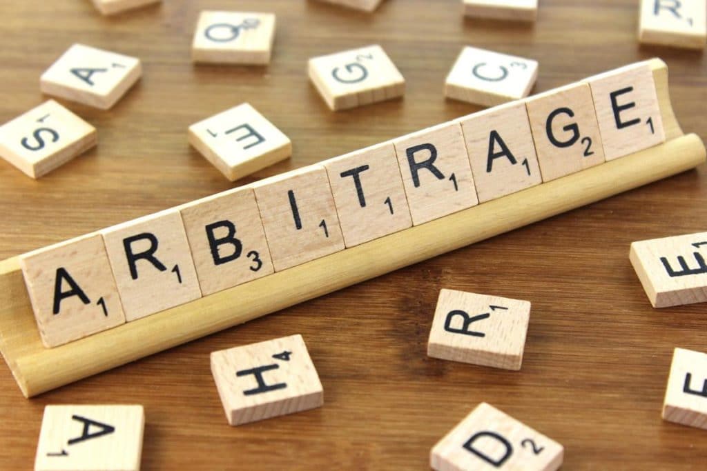 arbitrage spelled on scrabble deck