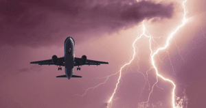 Airplane in sky with Lighting in the background