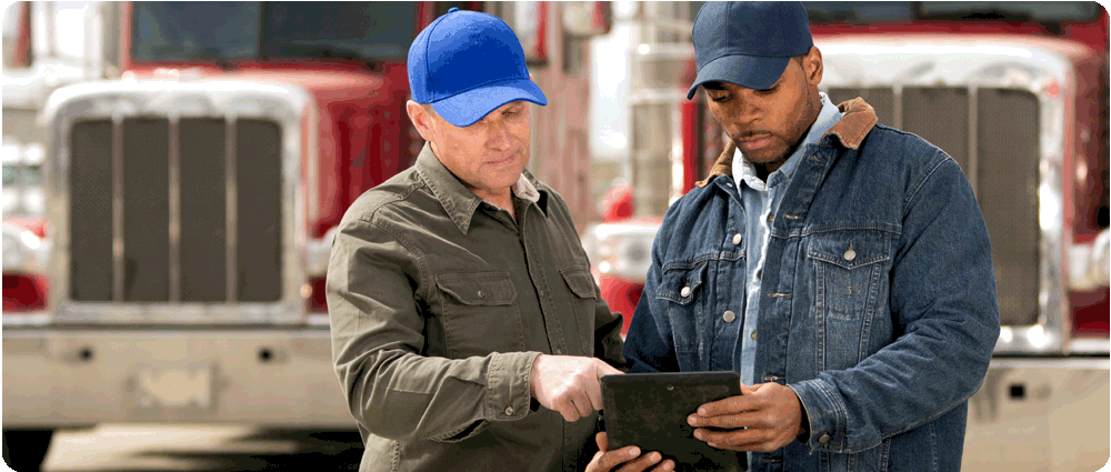 Fuel truck drivers looking at tablet