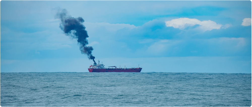 Container ship with exhaust in the distance