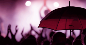 Person holding umbrella at outdoor event